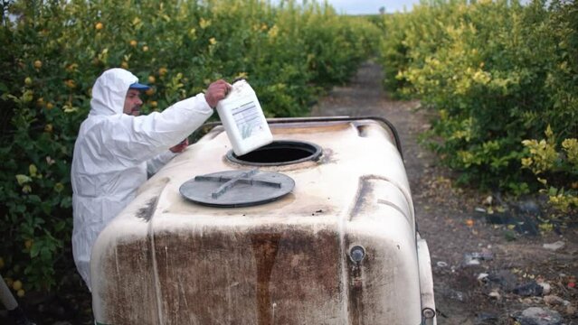 Tractor spraying pesticide drone aerial view, pesticides or insecticide spray on lettuce or iceberg field. Pesticides and insecticides on agricultural field in Spain