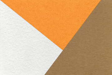 Fototapeta premium Texture of craft white, brown and orange shade color paper background, macro. Vintage abstract beige cardboard
