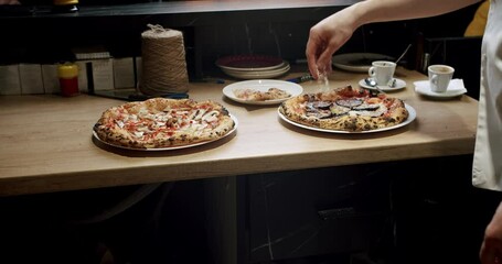 The chef prepares pizza in the restaurant kitchen. Italian Neapolitan pizza with large dough. work in the kitchen. Pizza is placed in the wood oven. Modern Oven. Pizza Food. 