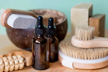 Aromatherapy. A glass bottle with a pipette for oil, lotion, cream, massage brushes and bath accessories. Natural organic eco-cosmetics. The layout of the corporate identity of the beauty salon.