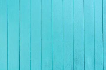 The Old turquoise wooden panel texture as background.