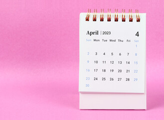 The April 2023 desk calendar on pink colour background.