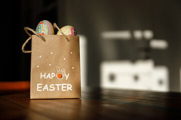 Happy easter, paper bag with painted eggs and copy space
