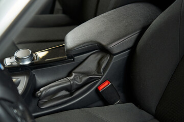 leather center armrest, handbrake and car settings control washer on the console, seat belt lock and button