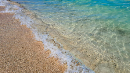 Ocean waves breaking at the beach. Beautiful beach of Alcudia Bay, Spain