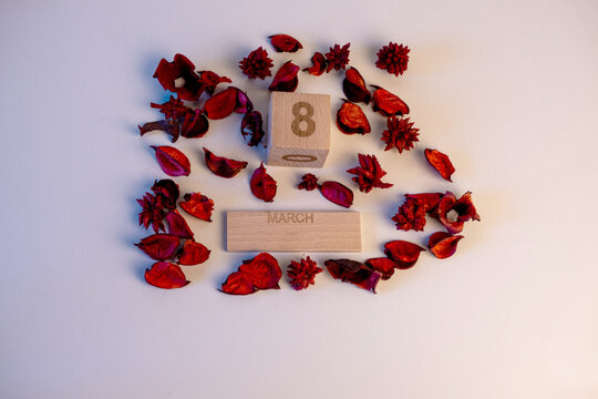 Calendario de madera marcando el d&iacute;a 8 de marzo con flores secas alrededor por el d&iacute;a internacional de la mujer.
