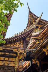 Traditional Chinese architecture details against clear blue sky in BaoLunSi temple Chongqing, China - 575985126