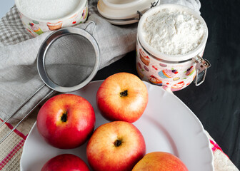 still life with apples spread out on a plate kitchen towel and flour