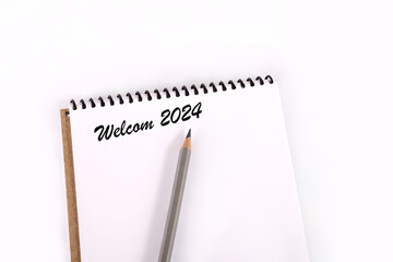 Text 2024 on a white background. New year 2024. Notepad and pencil on a white background. Business diary cover for 2024. planning concept 2024