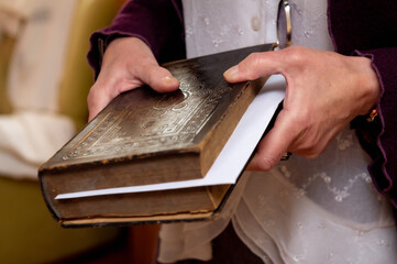 female hands holding an old bible