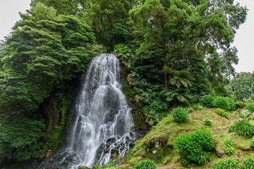 Fototapeta na wymiar Waterfall on Sao Miguel island, Azores / Waterfall in the interior of Sao Miguel island, Azores, Portugal.