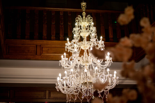 crystal chandelier in a wooden banquet hall