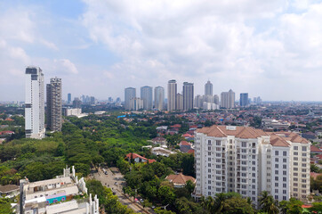 Obraz premium View of central Jakarta downtown CBD skyline with its greeneries and residential landed houses nearby. Jakarta serves as the major port and capital city of Indonesia.
