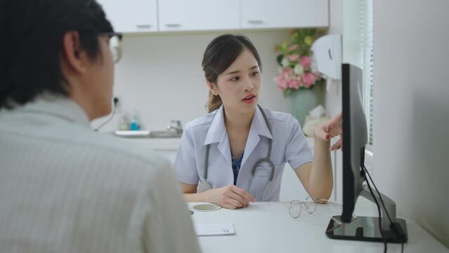 Asian professional woman doctor suggests healthcare solution to her patient in examination room at hospital.male patient explain health problem and symptoms to doctor
