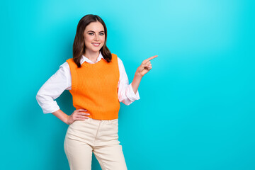 Portrait of positive adorable girl with straight hairdo wear white shirt directing empty space isolated on turquoise color background