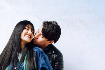 Photo of young couple looking at each other and kissing. Concept of lifestyle, love, friendship, affection and feelings.