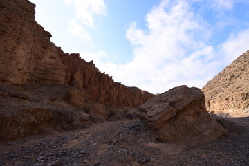 Sunny day on the road among the red canyons in the Tien Shan mountains