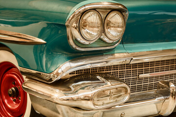 Side front view of a vintage green classic car with chrome accents - Powered by Adobe