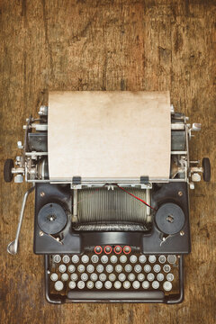 Top view of a vintage typewriter with empty sheet of paper