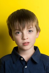 little boy portrait close-up on a yellow background