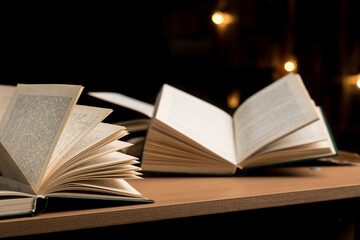 open books lie on the table on a black background