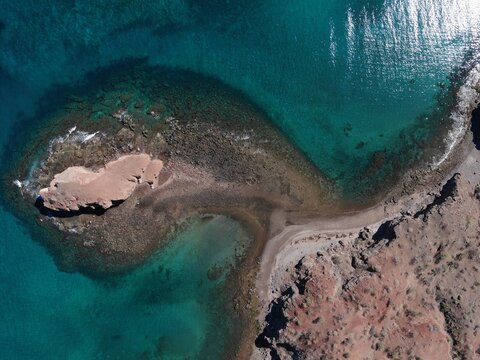 Top Down Aerial Shot Of Remote Rocky Peninsula And Calm Turquoise Water Bay On Sea Of Cortez Coast Of Baja