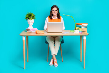 Photo of adorable smart clever lady learner wear stylish clothes sitting home library preparing test exam isolated on cyan color background