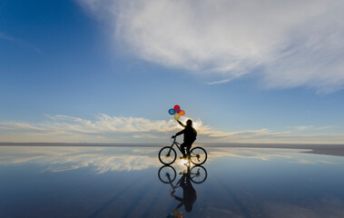 Fototapeta na wymiar person riding a bike in the sky