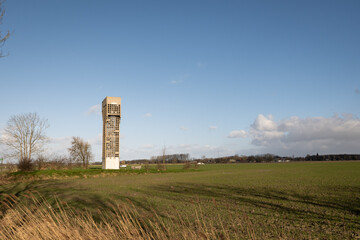 Fototapeta na wymiar Sky watch tower from the cold war in Dutch Stichting Luchtwachttoren 701 in rural area near Warfhuizen Groningen. the concrete structure was a lookout post for military defence purposes