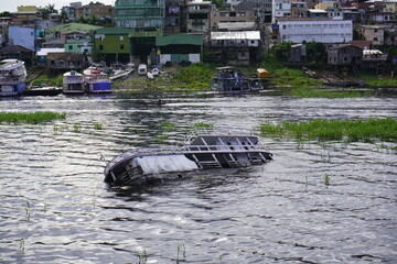 Capsized Amazon boat in the Rio Negro. Manaus - Amazonas, Brazil.