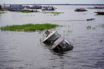 Capsized Amazon boat in the Rio Negro. Manaus - Amazonas, Brazil.