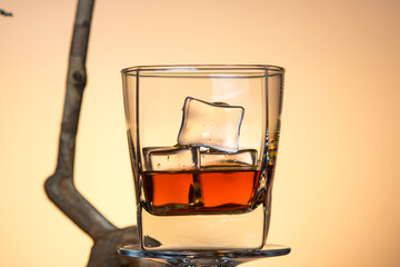 Glass of whiskey with ice. Strong alcoholic drink