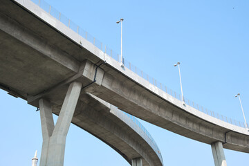 Elevated expressway during a sunny day .  highway overpass against blue sky .  Motorway viaduct...