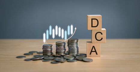 Wooden cube DCA text, stack of coins on wooden table and graph showing growth, finance and investment concept, long term goal dollar cost averaging, mutual fund, bond, digital asset, stock market