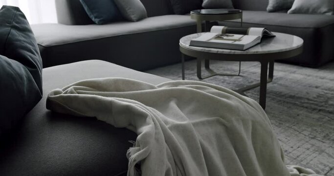 Modern contemporary Minimalist living room with grey furniture. Interior With Corner Sofa round table. Fashionable furniture. Minimalist Home Interior. Cozy Modern Furniture Design.Luxury Elegant Room