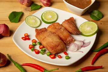  fried fish fillets served on white plate on old wooden top view, golden batter deep fried fish fillets,
lemon and orange slices, spices, concept - healthy seafood 