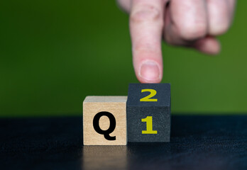 Symbol for the 2nd Quarter of the year. Hand turns dice and changes the expression Q1 to Q2.