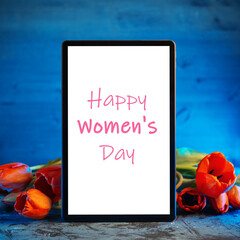 Happy women's day congratulations on the tablet, a bouquet of red tulips, blue background