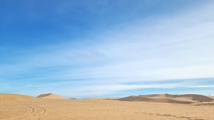 landscape of sand dune desert with blue sky. the white dunes (bau sen, bau trang). Mui Ne, Vietnam. famous travel destination of Vietnam. gold desert.