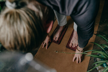 Man standing on wooden yogic board with metal nails