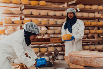 Muslim business partners checking the quality of cheese in the modern industry