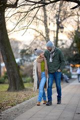 Embraced romantic couple enjoying a walk in the park