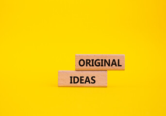 Original ideas symbol. Concept word Original ideas on wooden blocks. Beautiful yellow background. Business and Original ideas concept. Copy space.