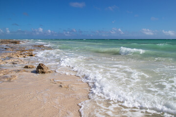 Fototapeta na wymiar waves on a rocky beach by the sea