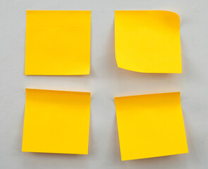 Blank yellow sticky note on the wall