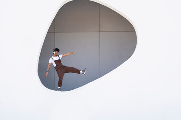 Young man enjoying on wall of building