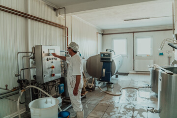 Cheese maker working in the modern industry on machines that are using for the machining of fresh cheese