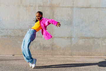 Dancer on tip toe in front of wall