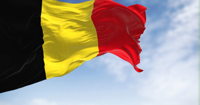 The national flag of Belgium waving on a clear day
