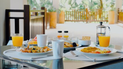 Variety of food on hotel breakfast buffet with tropical vibe